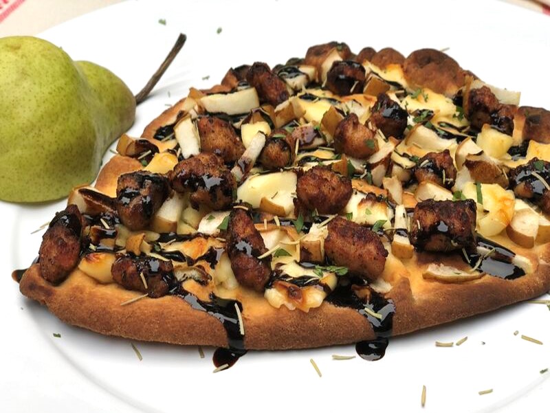 A delicious flatbread topped with brie pears and butcher-quality Premio sausage