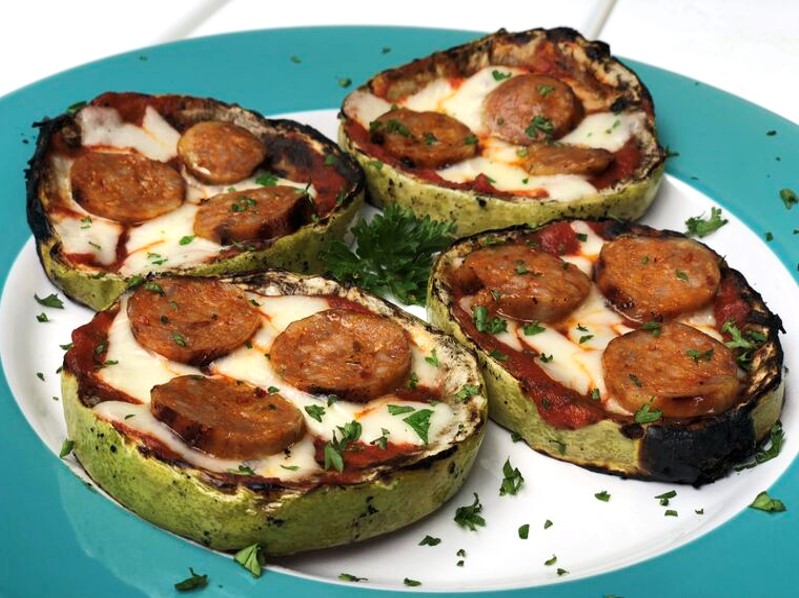 Mini Zucchini crust pizzas topped with sliced Premio hot & spicy Italian chicken sausage