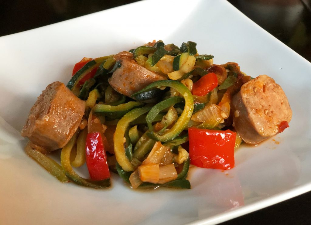 Zucchini noodles topped with delicious butcher quality Premio sausage and peppers