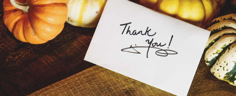 thank you note leaning on pumpkins