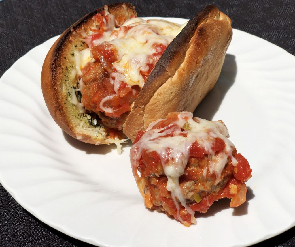 Craft a delicious cheesy sausage meatball sandwich with a toasted garlic hoagie