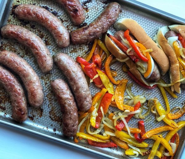 Butcher-quality Premio sausage cooked with onions and peppers on a sheet pan