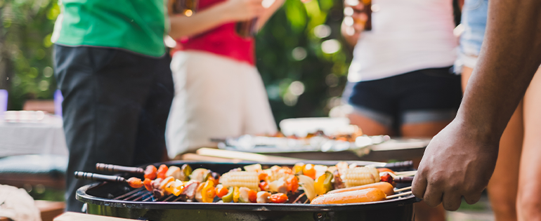 People Cooking on The Grill in Their Backyard