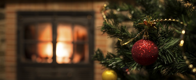 Christmas tree in front of fire place