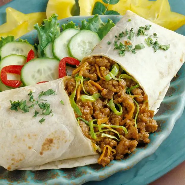 Thai Pork Burritos on blue plate with salad