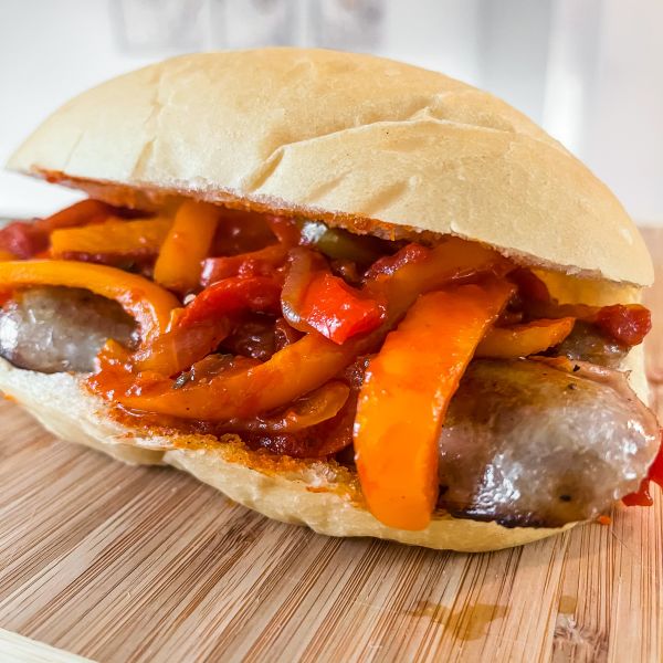 Sweet Italian Premio Sausage topped with tomato and onion mixture on a hoagie roll