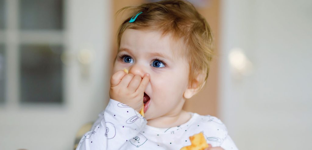 Toddler eating premio breakfast sausage