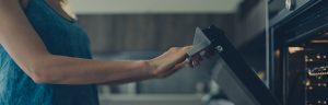 woman opening oven